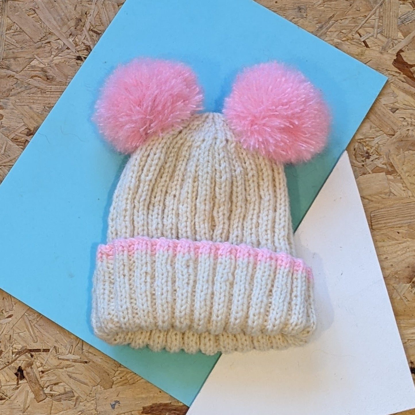 Kids hand knitted double pom pom hat