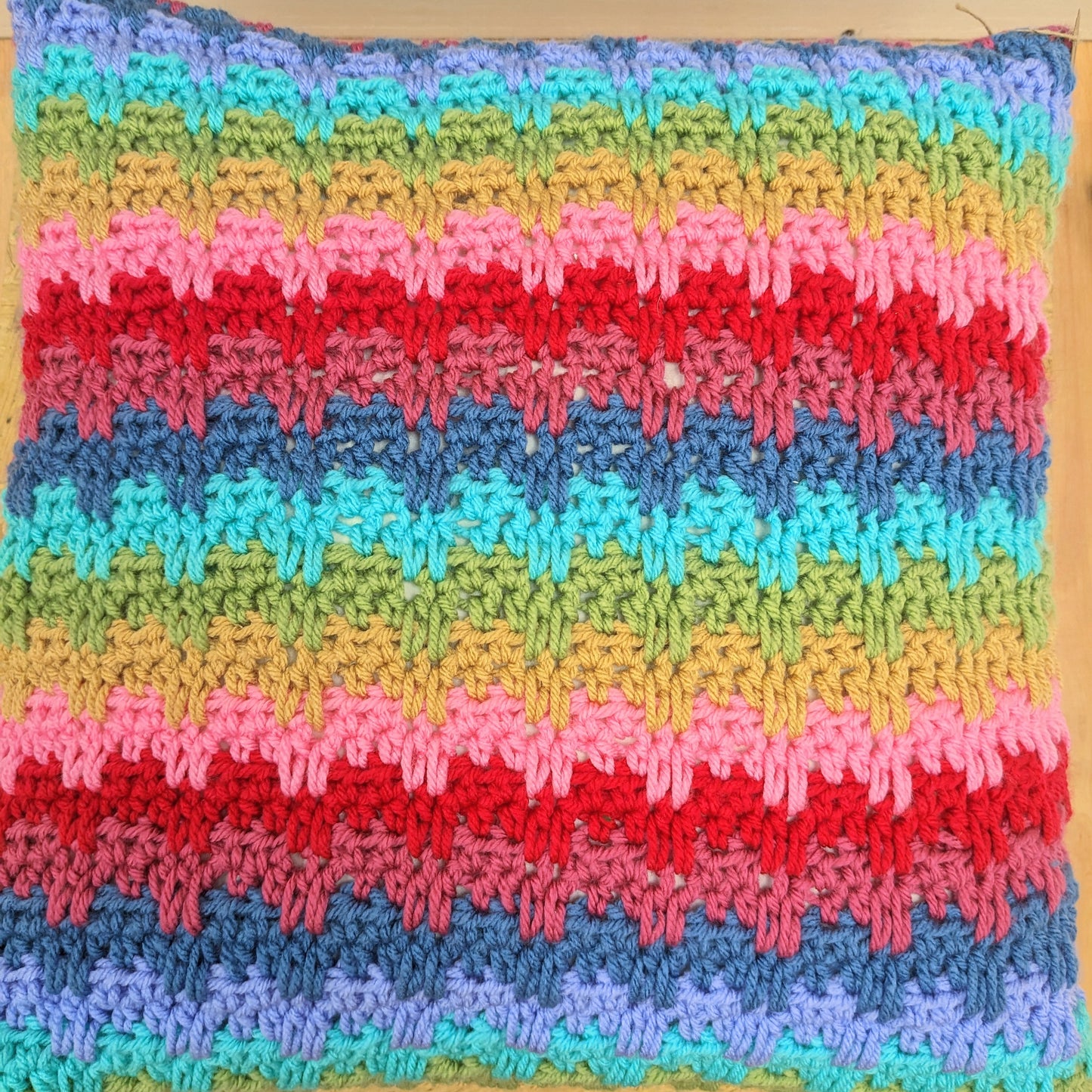 Large colourful handmade crochet pillow