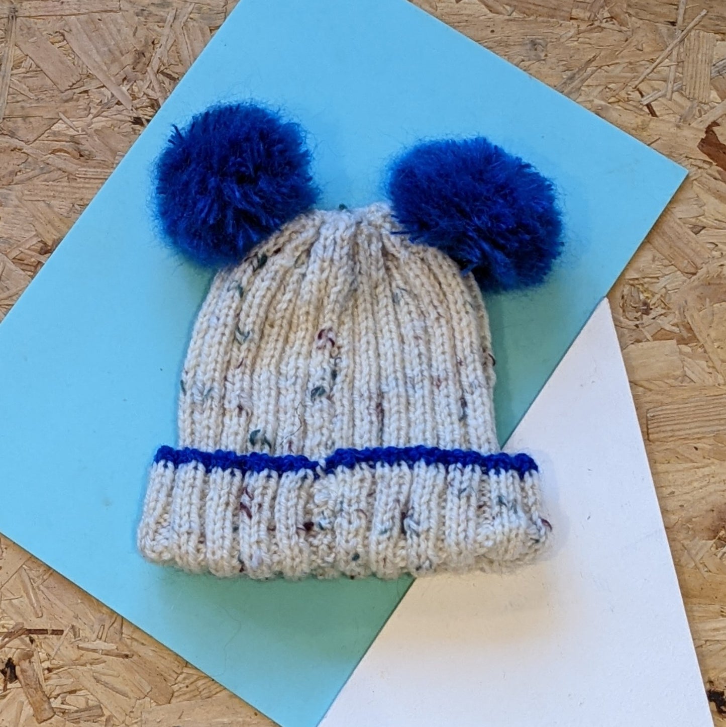 Kids hand knitted double pom pom hat